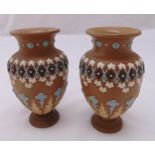 A pair of Doulton Silicon ware vases decorated with geometric forms and stylised leaves and flowers,