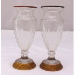 A pair of early 20th century glass vases with gilt metal collars and raised circular bases, 20cm (