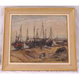 A framed oil on canvas of fishing boats on a beach, indistinctly signed bottom right, 50 x 60cm