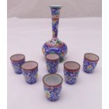 A Middle Eastern enamel and base metal vase and six matching tumblers decorated with flowers, leaves