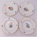 A set of four hand painted Royal Copenhagen plates decorated with floral sprays, each 24.5cm (d)