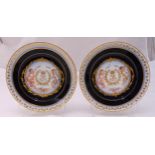 A pair of Sevres cabinet plates decorated with putti amidst flowers and leaves, marks to the