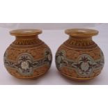 A pair of Doulton Silicon ware vases of compressed globular form with applied stylised scrolls and