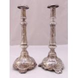 A pair of late 19th century Polish white metal table candlesticks of tapering cylindrical form,