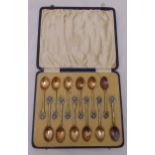 A cased set of twelve hallmarked silver and enamel coffee spoons, Birmingham 1934