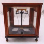 L. Oertling Ltd of London, scientific precision brass beam balance scales in a rectangular glazed