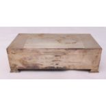 A hallmarked silver rectangular cedar wood lined cigarette box on four bracket feet