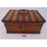 A late 19th century rectangular walnut jewellery casket with applied iron strap work, the hinged