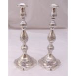 A pair of hallmarked silver table candlesticks, knopped baluster stems on shaped square bases,