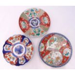 Three oriental Imari chargers decorated with flowers, fruit trees, ducks and exterior scenes,