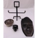 A quantity of curios to include a carved ebony mask and a bronze candle holder (4)