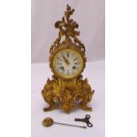 A French 19th century ormolu mantle clock, the rococo case with circular enamel dial and Roman