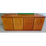 A mid 20th century Danish Rosewood rectangular sideboard the four hinged doors opening to reveal