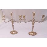 A pair of hallmarked silver three light candelabra, fluted oval stems on shaped oval bases,