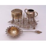 A quantity of white metal to include a covered box, a tea strainer, a toast rack and a two handled