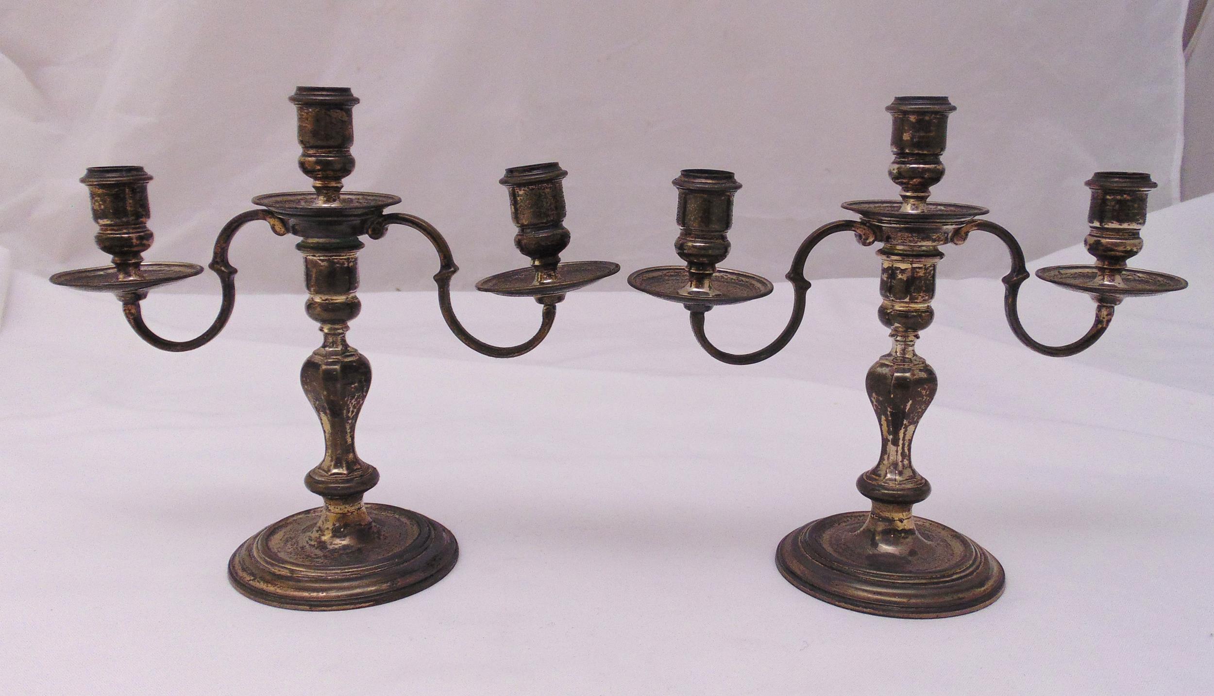 A pair of hallmarked silver three light candelabra, panelled baluster stems on raised circular