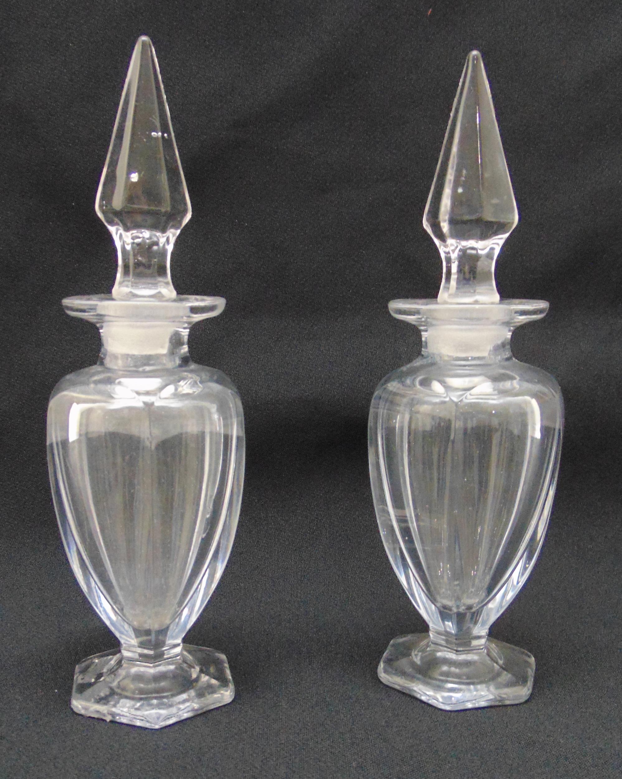 A pair of Chippendale glass crystal scent bottles, the pear shaped bodies on hexagonal bases with