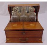 A three bottle Tantalus rectangular mahogany and satinwood case with hinged covers and a single