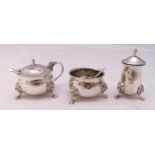 A hallmarked silver three piece condiment set and two condiment spoons (5)