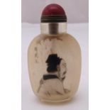 A Chinese reverse painted snuff bottle with an image of an elder and Chinese characters, 9cm (h)