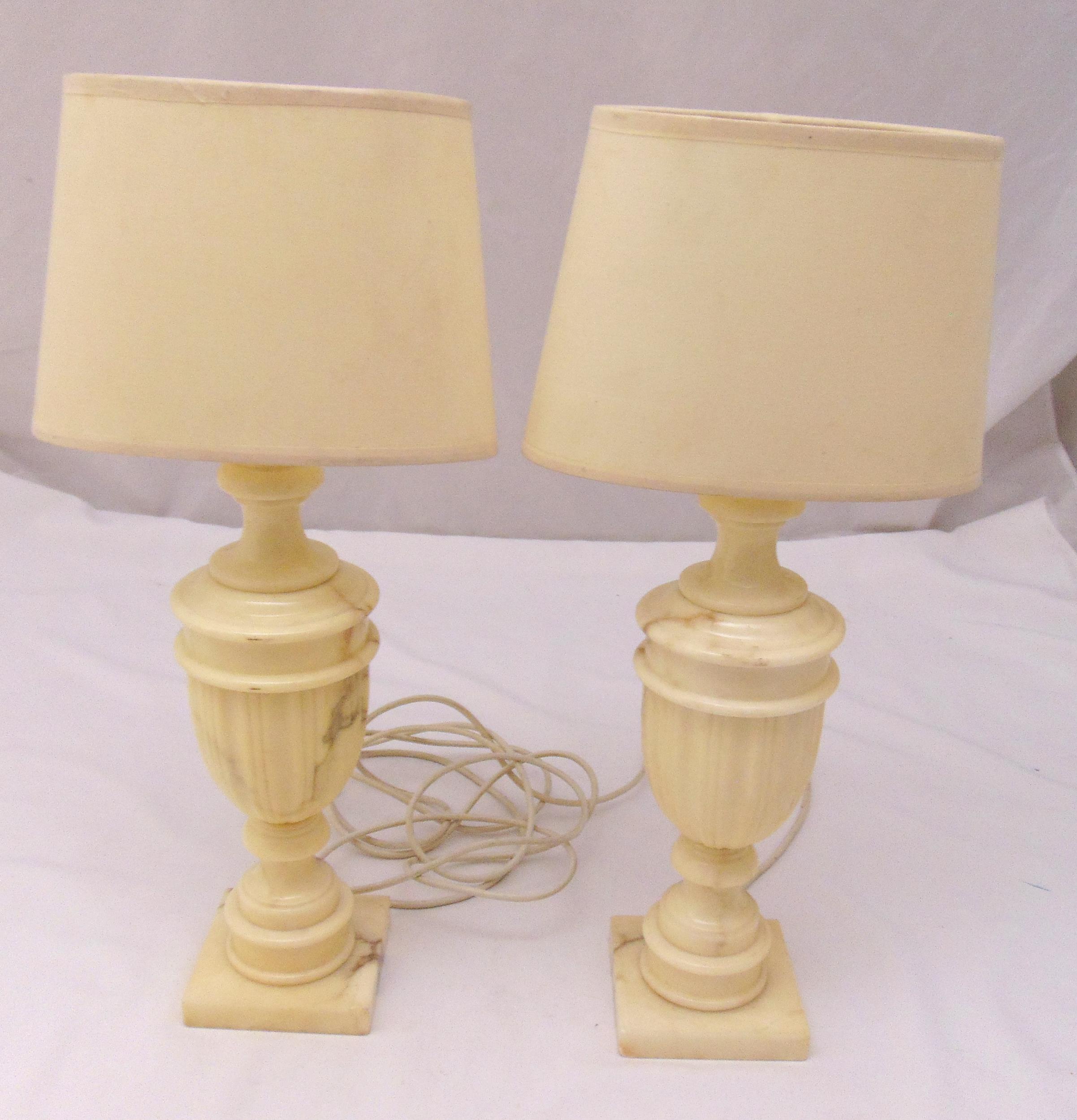 A pair of white marble urn shaped table lamps on square bases, height with shades 54cm