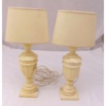 A pair of white marble urn shaped table lamps on square bases, height with shades 54cm