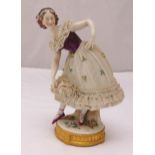 A Sitzendorf porcelain figurine of a lady dancer on raised circular base, mark to the base, A/F (
