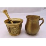 A brass tankard with scroll handle and a pestle and mortar of customary form, tallest 11cm (h)