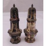 A pair of hallmarked silver sugar sifters, panelled sides with pierced pull off covers on raised