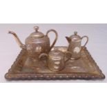 An Indian three piece white metal bachelor teaset with matching tray