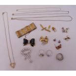 A quantity of costume jewellery to include rings, brooches, earrings, a bracelet and chains