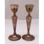 A pair of hallmarked silver table candlesticks, fluted tapering stems on circular spreading bases,