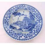 A Chinese blue and white charger decorated with stylised landscapes, 41cm (dia)