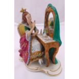 Dresden figurine of a lady seated at a dressing table, marks to the base, 18.5 x 17 x 9.5cm