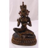 A Chinese gilded bronze Buddha on raised oval base, 38cm (h)
