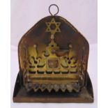 A brass Menorah of shaped rectangular form carved and pierced with receptacles for oil surmounted by