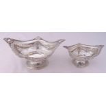 Two Victorian hallmarked silver pierced oval dishes, with husk and shell borders, rosettes and swags