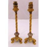 A pair of gilt metal table candlesticks, the ivy bound columns on triform claw feet, converted to
