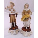 A pair of continental figurines of a girl carrying flowers and a boy with a hat, mounted on raised