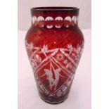 A Bohemian overlaid red glass vase etched with dancing figures and geometric forms, 31cm (h)