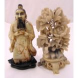 An oriental carved soapstone figurine of an elder and a carved soapstone floral display, tallest