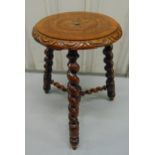 An oak circular milking stool on three barley twist legs and stretchers, 46 x 30cm