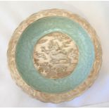 A Chinese celadon dish with applied silvered decoration, marks to the base, 19cm (dia)