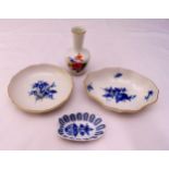 A quantity of Meissen porcelain to include three blue and white dishes and a miniature vase, tallest