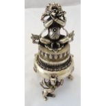 A Tibetan white metal censor of cylindrical form, pull off cover with figural finial on cast