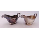 A pair of hallmarked silver sauce boats, oval, panelled, reeded borders with angled handles,