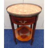 A continental circular side table with single drawer, brass mounts and pierced gallery metal and