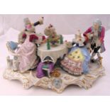 A Crown Naples ceramic figural group of figures drinking and dining in 18th century costume on