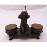 A late 19th century French inkstand with central cast putti, the two wells in the form of drums on