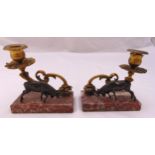 A pair of table candlesticks with leaf scroll mounts and stags on raised rectangular base, 13cm (h)